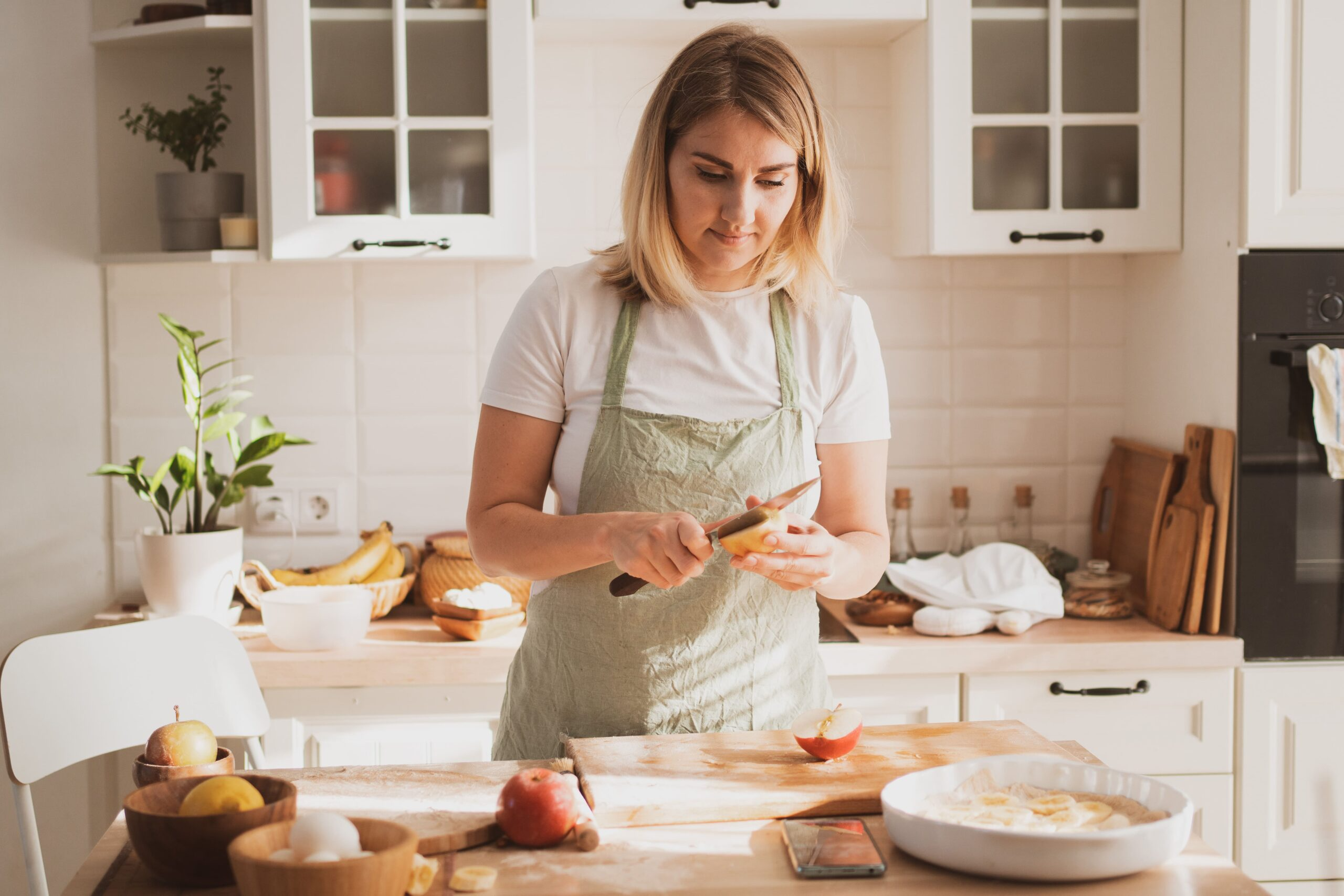 charming young woman chef s apron preparing pie home kitchen cozy home interior min scaled