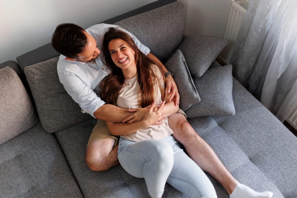 couple hugging relaxing home min scaled (1)