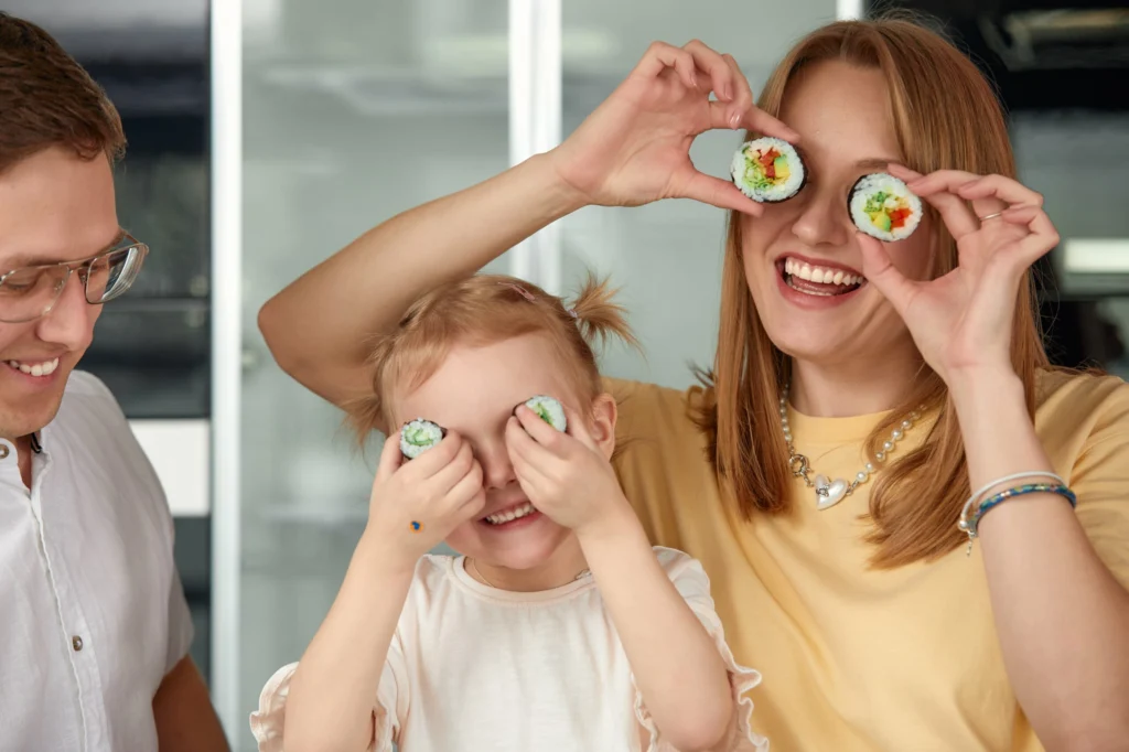 happy caucasian family having fun eating sushi rolls kitchen home min scaled