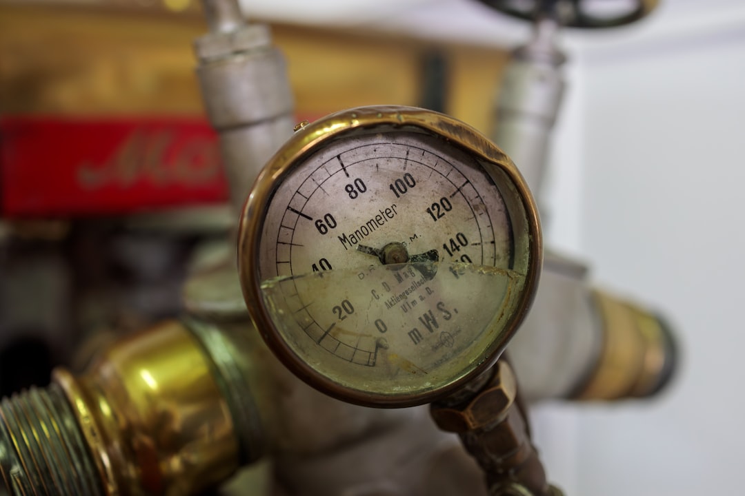 digital manifold gauge measuring heat pump system pressure - how refrigerant leaks affect heat pump performance