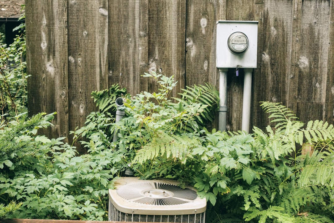 modern air-source heat pump installed in a sunny Orange County backyard