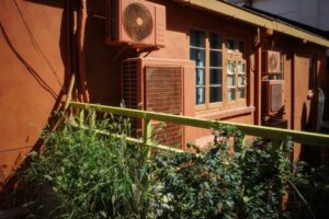 modern AC unit outside an Orange County home with EPA regulation concept overlay