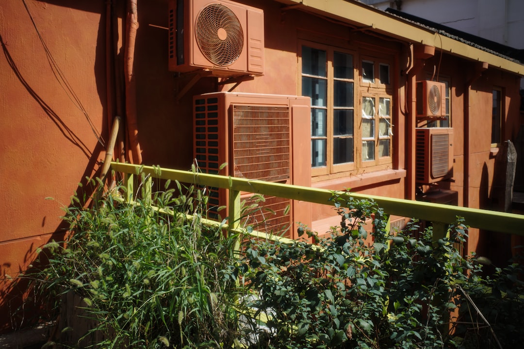 modern AC unit outside an Orange County home with EPA regulation concept overlay